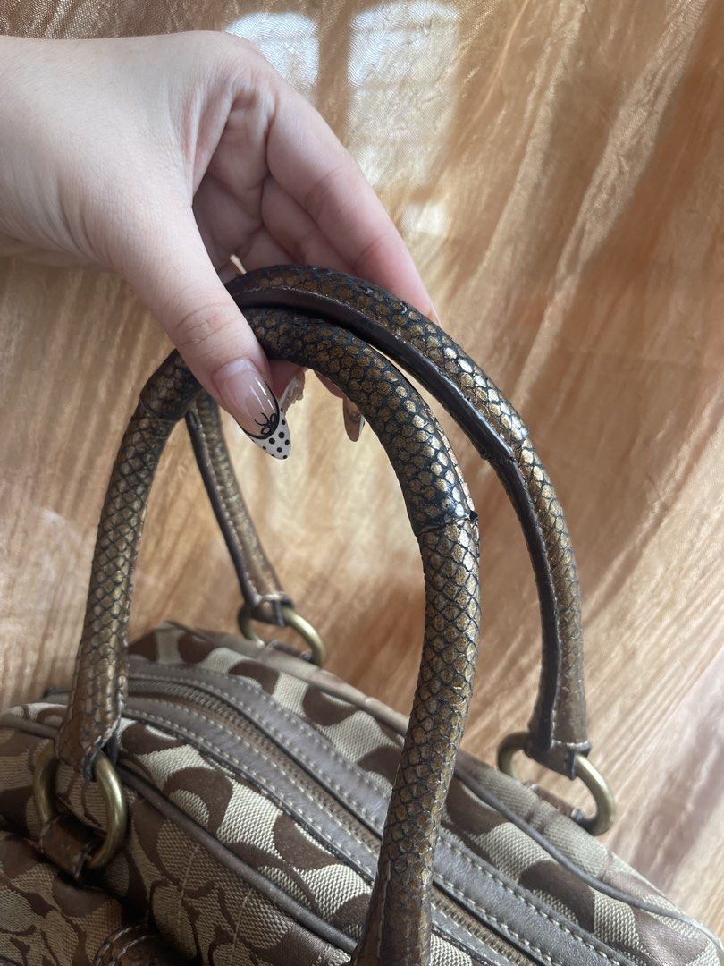 Coach Soho Monogram Canvas & Leather Trimmed Handbag (Category: Luxury Bags & Wallets) located in Davao. Submitted by boodle4lyf (Listing ID 1443196948, Image 2). Description: Classic Coach monogram canvas bag with leather trim and brass hardware. Handles show wear (see pics). Corners are already faded but no rubs or open pipings. Interior is dirty already and needs cleaning. .