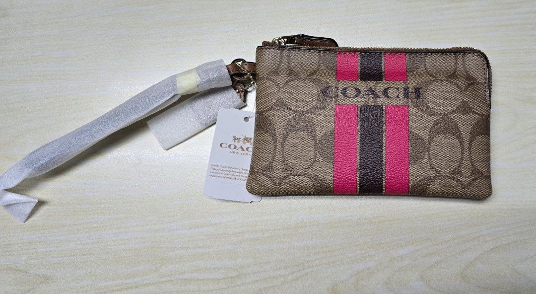 COACH VARSITY STRIPE CORNER ZIP WRISTLET SIGNATURE KHAKI PINK RUBY (Category: Purses & Pouches) located in Manila. Submitted by shoppe_22 (Listing ID 1443192551, Image 3). Description: COACH VARSITY STRIPE CORNER ZIP WRISTLET SIGNATURE KHAKI PINK RUBY bought for $50 at coach outlet store. selling low because i already have too much wallet. slightly negotiable but no lowballers please description: The zip-top closure opens to a fabric-lined interi