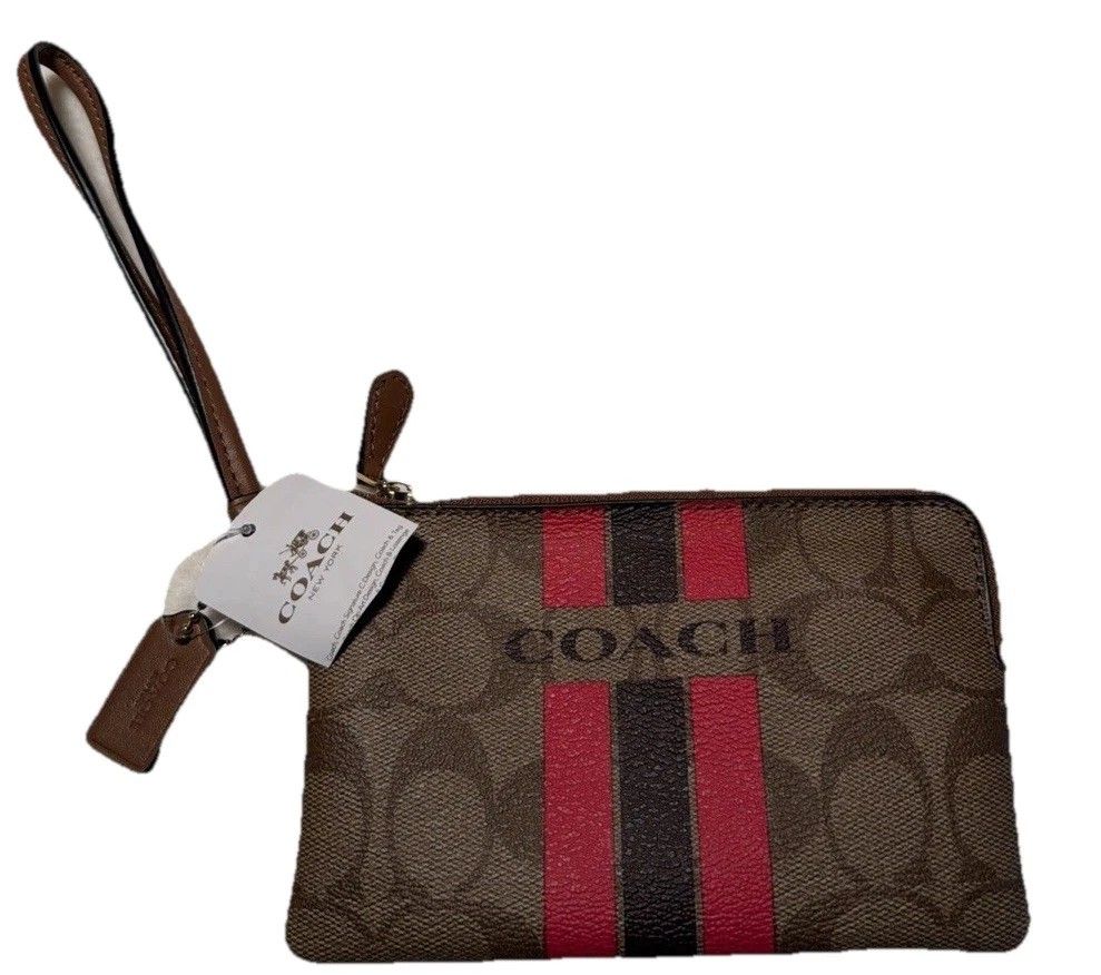COACH VARSITY STRIPE CORNER ZIP WRISTLET SIGNATURE KHAKI PINK RUBY (Category: Purses & Pouches) located in Manila. Submitted by shoppe_22 (Listing ID 1443192551, Image 2). Description: COACH VARSITY STRIPE CORNER ZIP WRISTLET SIGNATURE KHAKI PINK RUBY bought for $50 at coach outlet store. selling low because i already have too much wallet. slightly negotiable but no lowballers please description: The zip-top closure opens to a fabric-lined interi
