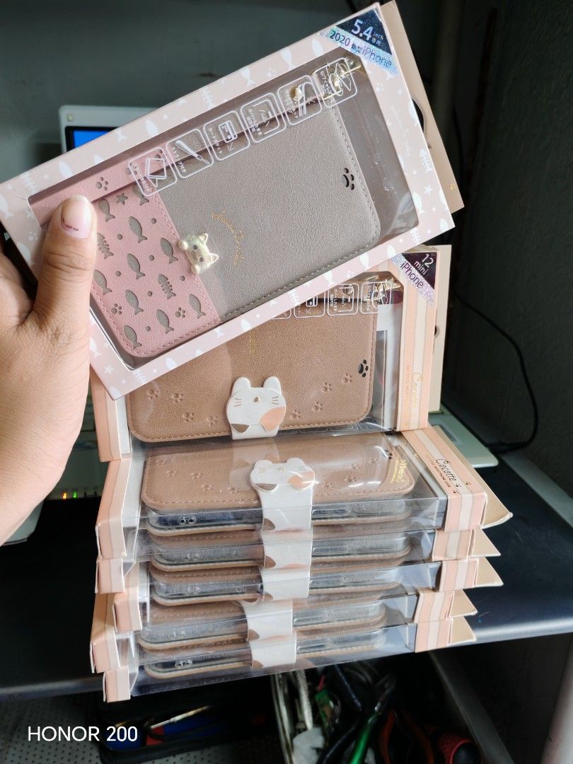 Cute Cat Phone Case for iPhone 12 (Category: Cases & Sleeves) located in Manila. Submitted by mariceloch01539 (Listing ID 1443133799, Image 1). Description: - Wallet-style phone case with card slots - Adorable cat design on the front - Fits iPhone 12 - Provides great protection - Super cute and functional!.