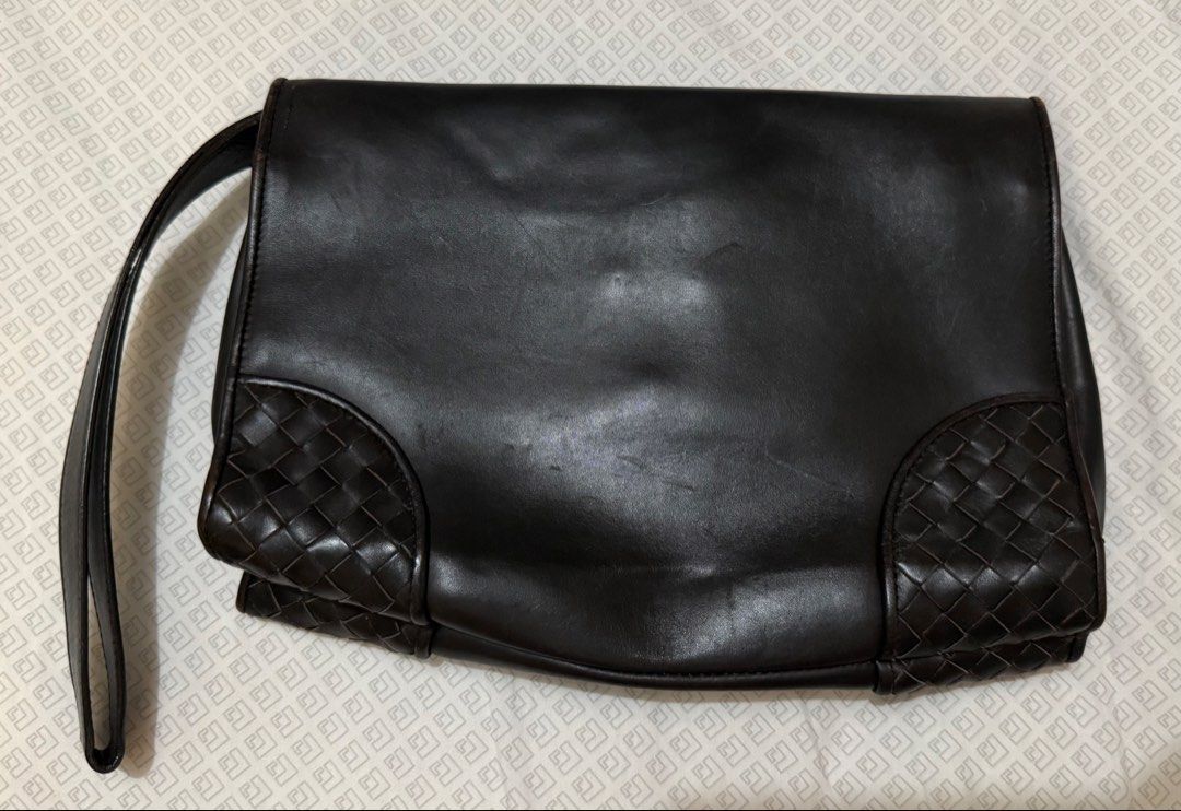 Dark Brown Bottega Venetta Clutch (Category: Luxury Bags & Wallets) located in Pasay City. Submitted by karlaa87 (Listing ID 1443240598, Image 2). Description: - Dark brown leather clutch - Unique woven details on corners and flap - Secure metal clasp closure - Adjustable strap for comfort - Spacious interior for all your essentials - Versatile: great for everyday or special occasions.