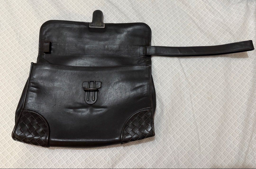 Dark Brown Bottega Venetta Clutch (Category: Luxury Bags & Wallets) located in Pasay City. Submitted by karlaa87 (Listing ID 1443240598, Image 3). Description: - Dark brown leather clutch - Unique woven details on corners and flap - Secure metal clasp closure - Adjustable strap for comfort - Spacious interior for all your essentials - Versatile: great for everyday or special occasions.