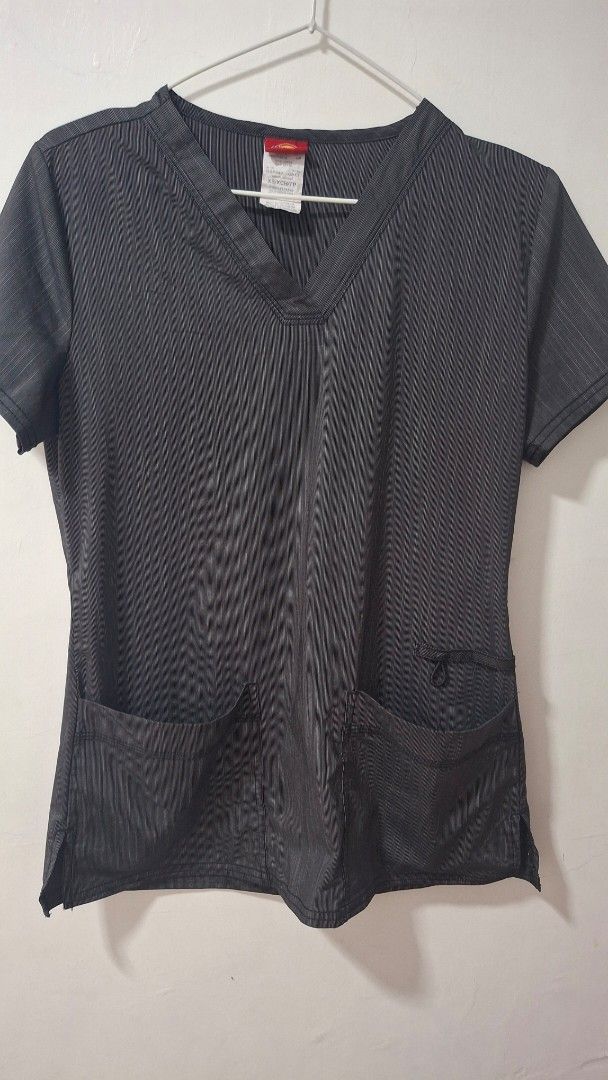 Dickies Grey Striped V-Neck Scrub Top (Category: Others Tops) located in Quezon City. Submitted by _helpmedeclutter (Listing ID 1443163593, Image 1). Description: - Grey scrub top with subtle vertical stripes - V-neck design - Two front pockets - Small loop detail on left chest pocket - Short sleeves - Comfortable and practical for work.