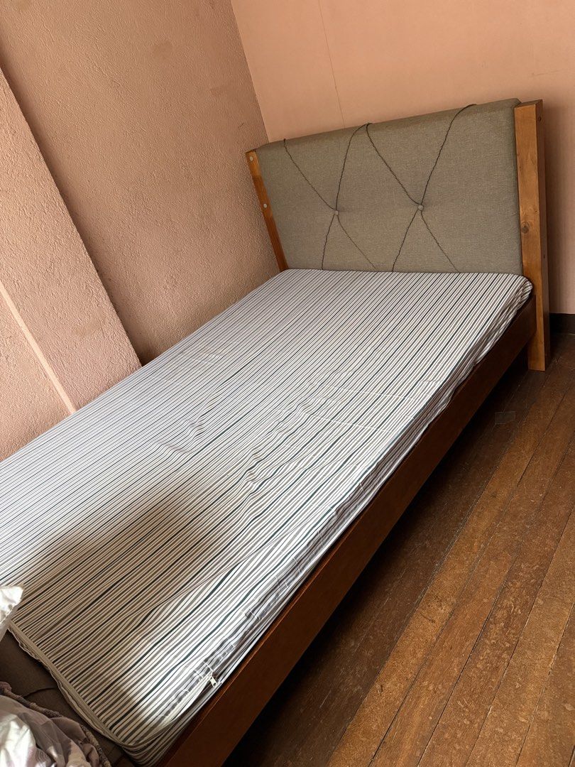 Double Bed Frame with Upholstered Headboard (Category: Bed Frames & Mattresses) located in Pasig City. Submitted by paunicolas19 (Listing ID 1443265039, Image 1). Description: - Double bed frame with 48” foam mattress - Grey upholstered headboard and a sturdy wooden base and legs. - Includes a slatted base for optimal mattress support. - Designed for easy assembly, perfect for any bedroom or guest room..