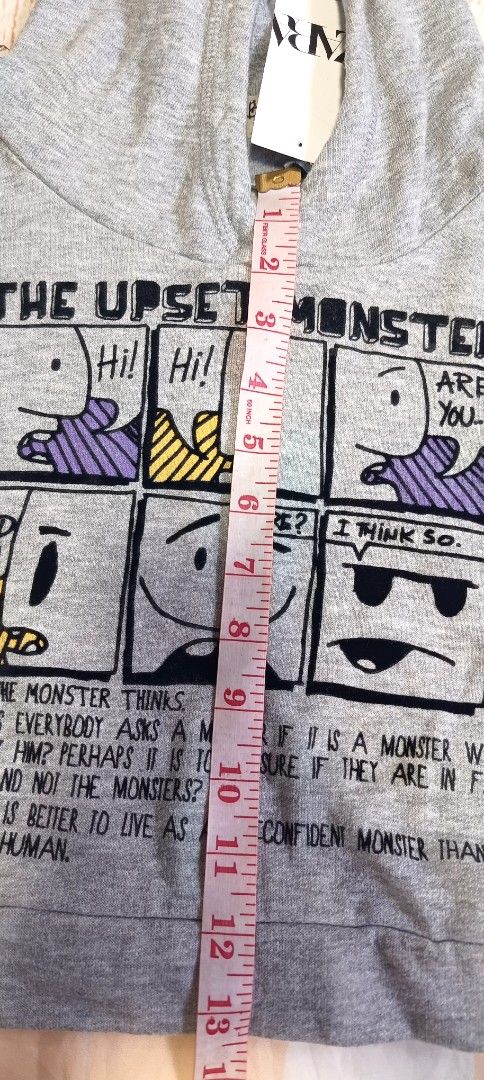 Zara Grey 'The Upset Monster' Hoodie (Category: Babies & Kids Fashion) located in Davao. Submitted by fabmegashop (Listing ID 1443243219, Image 3). Description: - Grey hoodie with fun comic strip graphic - Features 'The Upset Monster' theme - Long sleeves and hood - Ideal for casual wear - Measurements: Length approx 13 inches, Chest approx 11 inches.