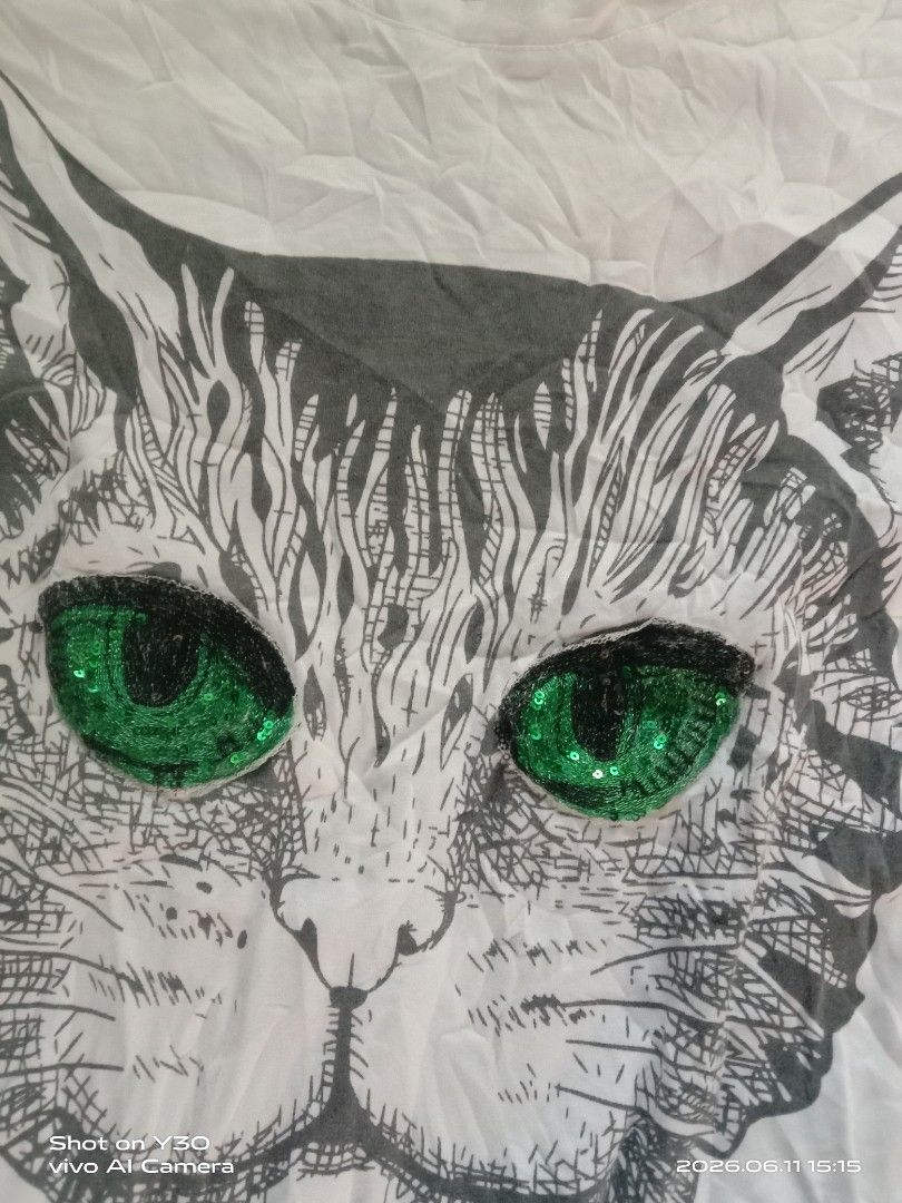 Gucci White Cat "GUCCIFICATION" Sequin T-Shirt (Category: Luxury Apparel) located in Cabuyao City. Submitted by blake657 (Listing ID 1443194527, Image 3). Description: - Authentic white Gucci T-shirt - Features a cool cat graphic - Cat's eyes are sparkling green sequins - "GUCCIFICATION" text in vibrant red sequins - Genuine Gucci tag - Perfect statement piece to elevate your style.