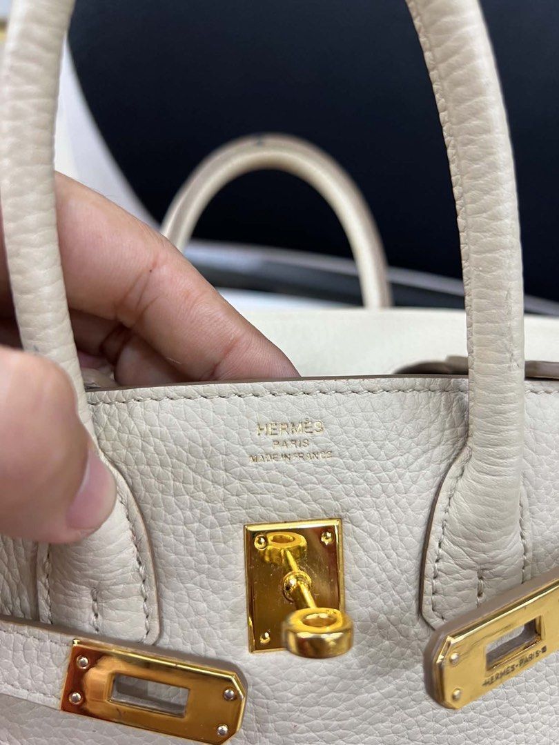 Hermes Birkin Bag - Beige Leather (Category: Luxury Bags & Wallets) located in Bacolod City. Submitted by novymaesel14868 (Listing ID 1443315027, Image 3). Description: - Authentic Hermes Birkin Bag - Material: Beige Togo Leather - Hardware: Gold - Condition: Good overall, with some signs of wear - Features: Timeless design, suitable for everyday or special occasions - Authenticity: Stamp visible.