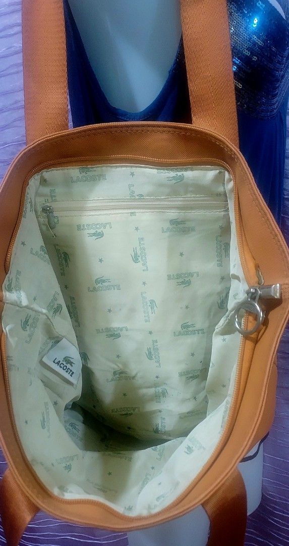 Lacoste Orange Tote Bag, Water resistant. (Category: Tote Bags) located in Taytay. Submitted by ForQueens (Listing ID 1443292172, Image 3). Description: - Orange Lacoste Tote Bag - Durable Material - Interior lining with all-over Lacoste logo pattern - Secure Zipper Closure - Spacious design, ideal for everyday use or travel Please manage your expectations. Available as long as it is posted. No cancellation..