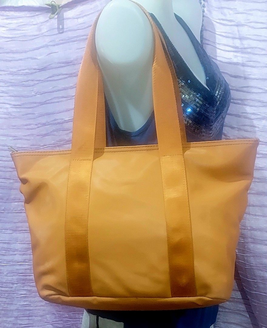 Lacoste Orange Tote Bag, Water resistant. (Category: Tote Bags) located in Taytay. Submitted by ForQueens (Listing ID 1443292172, Image 2). Description: - Orange Lacoste Tote Bag - Durable Material - Interior lining with all-over Lacoste logo pattern - Secure Zipper Closure - Spacious design, ideal for everyday use or travel Please manage your expectations. Available as long as it is posted. No cancellation..