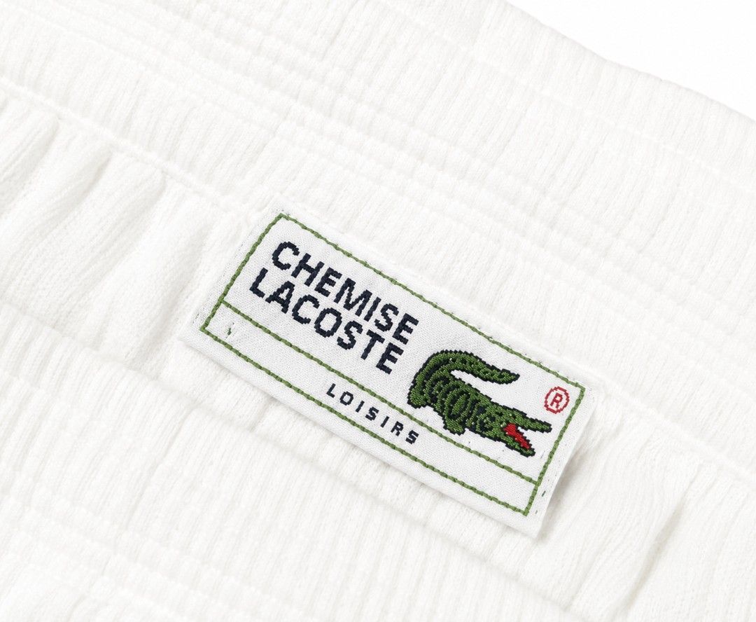 Lacoste White Corduroy Shorts (Category: Shorts) located in Vallehermoso. Submitted by threy (Listing ID 1443239869, Image 3). Description: - White corduroy shorts from Lacoste - Features the iconic crocodile logo on the left leg - Elastic waistband with drawstring for a comfortable fit - Ideal for casual wear or lounging - Simple and classic design.