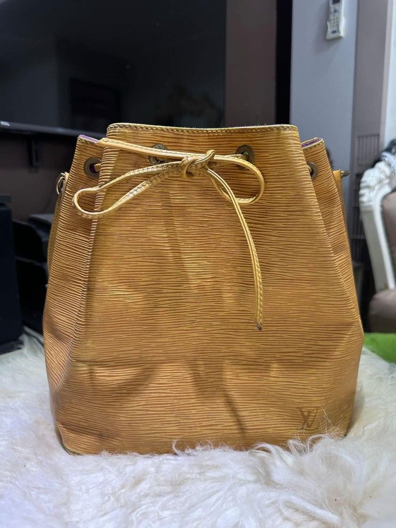 Louis Vuitton Epi Leather Bucket Bag (Category: Luxury Bags & Wallets) located in Batangas. Submitted by fendi.closet (Listing ID 1443192298, Image 2). Description: - Authentic Yellow Epi Leather Louis Vuitton Bucket Bag - Chic Purple Interior - Secure Drawstring Closure - Durable Leather Straps - Iconic LV Design - Ideal for Everyday Use - Generously Spacious.