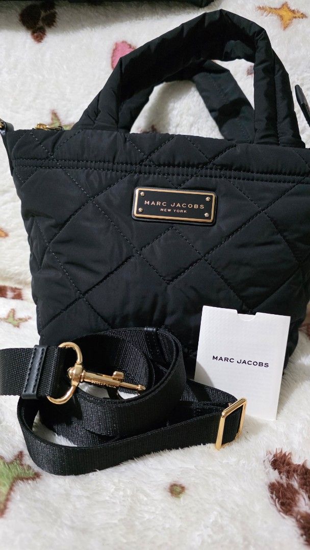 Marc Jacobs Quilted Nylon Mini Tote Bag (Category: Luxury Bags & Wallets) located in Mandaluyong City. Submitted by mlstuff28 (Listing ID 1443251842, Image 1). Description: - Authentic - Material: Quilted nylon - Color: Black - Style: Mini tote bag - Features: Top handles, detachable crossbody strap, gold hardware, interior zip pocket - Ideal for: Everyday use, travel Mop: bank transfer/ gcash.