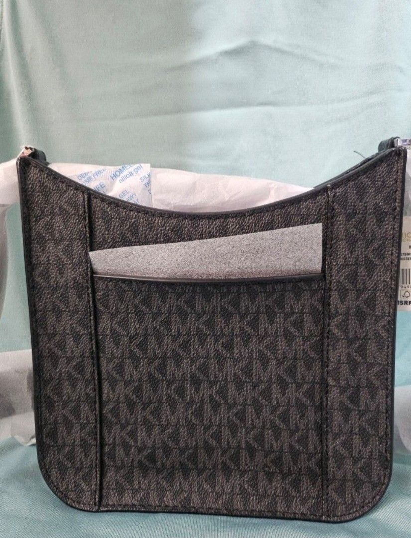 Michael Kors Signature Logo Shoulder Bag (Category: Shoulder Bags) located in Manila. Submitted by aituy (Listing ID 1443202074, Image 3). Description: • Brandnew and Authentic • US bought MK Briley Small Logo Messenger Bag • Silver Hardware • Plain Black Guitar Strap • Messenger bag • Model number 35S1S7BM1B • Logo-print canvas (Black Monogram) • 69% coated canvas/17% polyester/13% cotton/1% polyurethane • 7.75”W X 7.75”H X 2.5”D • Exterior deta