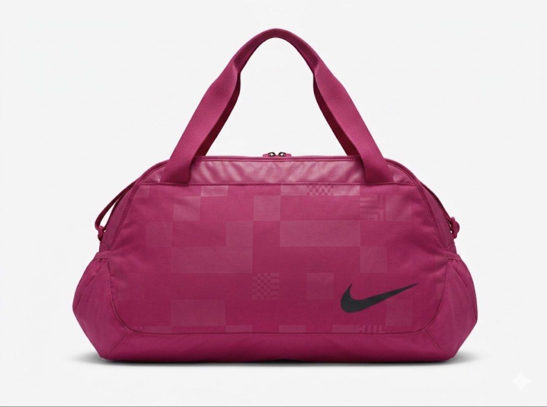 Nike Pink Duffle Bag Gym (Category: Other Sports Equipment and Supplies) located in Dasmarinas. Submitted by cess_declutters (Listing ID 1443267370, Image 1). Description: - Stylish pink Nike duffel bag - Unique patterned texture on the front - Prominent and clear Nike logo - Dual carrying options: two top handles and an adjustable shoulder strap - Ample interior space for all your essentials - Ideal for gym sessions, weekend getaways, or travel.
