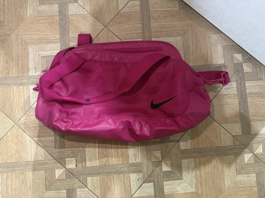 Nike Pink Duffle Bag Gym (Category: Other Sports Equipment and Supplies) located in Dasmarinas. Submitted by cess_declutters (Listing ID 1443267370, Image 3). Description: - Stylish pink Nike duffel bag - Unique patterned texture on the front - Prominent and clear Nike logo - Dual carrying options: two top handles and an adjustable shoulder strap - Ample interior space for all your essentials - Ideal for gym sessions, weekend getaways, or travel.