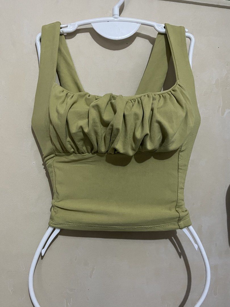 Olive Green Ruched Bust Crop Top Tank (Category: Others Tops) located in Malabon City. Submitted by abeilleshop (Listing ID 1443167877, Image 1). Description: - small - stretchable - Cute olive green crop top - Ruched detail on the bust - Square neckline - Tank straps - Stretchy material - Versatile: pairs well with high-waisted jeans or skirts - Suitable for casual outings or nights out.