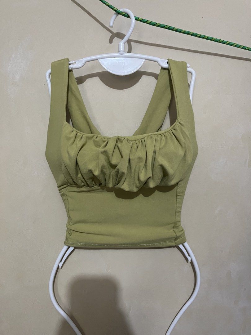 Olive Green Ruched Bust Crop Top Tank (Category: Others Tops) located in Malabon City. Submitted by abeilleshop (Listing ID 1443167877, Image 2). Description: - small - stretchable - Cute olive green crop top - Ruched detail on the bust - Square neckline - Tank straps - Stretchy material - Versatile: pairs well with high-waisted jeans or skirts - Suitable for casual outings or nights out.