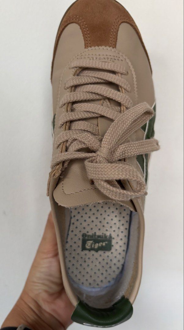 Onitsuka Tiger Mexico 66 Beige Green Suede Sneakers (Category: Sneakers) located in Singapore. Submitted by liu800 (Listing ID 1443316623, Image 3). Description: - Classic Onitsuka Tiger Mexico 66 sneakers - Beige and brown suede with iconic green stripes - Perfect for casual, everyday wear - Durable soles with excellent grip - Comes with beige laces - A stylish addition to any outfit - Size is US 6.5 & 24.5cm.