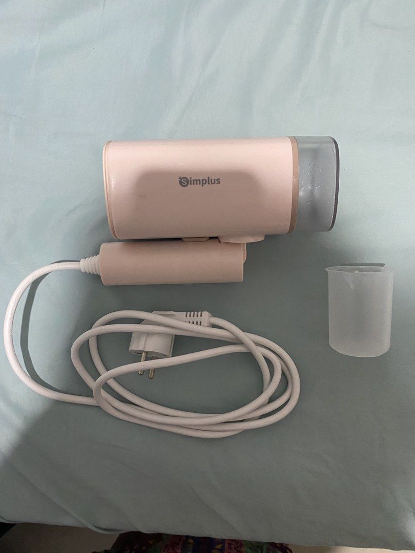 Simplus Steam Iron Handheld (Category: Irons & Steamers) located in Santa Rosa. Submitted by vieldrosar97998 (Listing ID 1443235780, Image 1). Description: Details - used a few times for events only - used with care - distilled water only - no box included - measuring cup still onhand.
