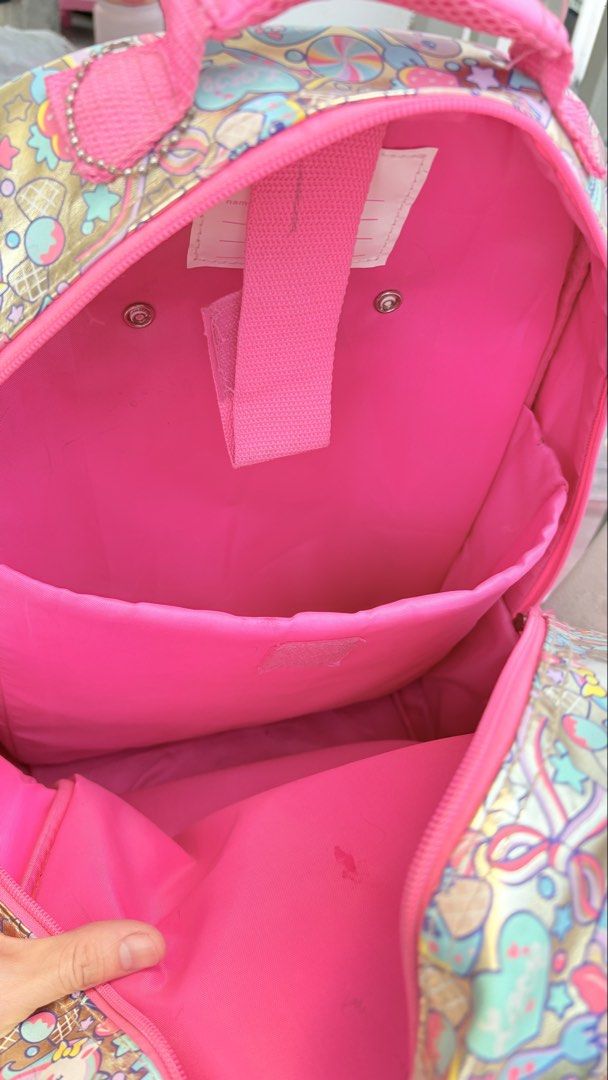 Smiggle Sequin & Print Rolling Backpack and Lunchbox Set (Category: Babies & Kids Fashion) located in Cavite. Submitted by savannahluish (Listing ID 1443162580, Image 3). Description: - Note: Minor scuffs present on the wheels and the back of the backpack straps. laba lang po mukhang bago na ulit. last year lang po eto nagamit may kapalitan pa kaya hndi po gamit na gamit.
