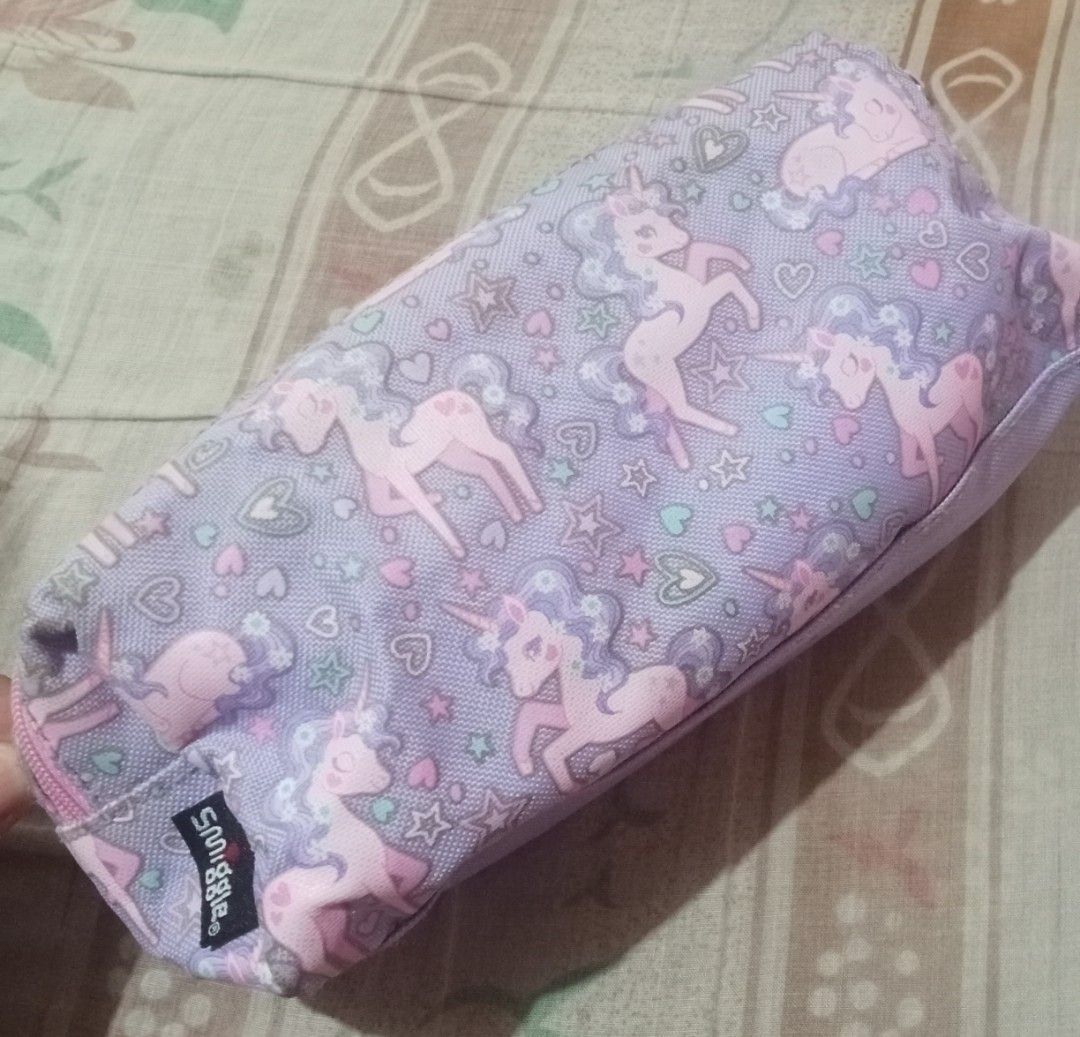 Smiggle Unicorn Pencil Case (Category: Stationery & School Supplies) located in Iloilo. Submitted by princessd99218 (Listing ID 1443286427, Image 2). Description: - Adorable Smiggle pencil case featuring a charming unicorn print. - Beautiful pastel purple and pink color scheme. - Ample interior space to hold all your pens, pencils, and stationery. - Smooth and durable zipper for easy access. - Ideal for school, art classes, or organizing craft su