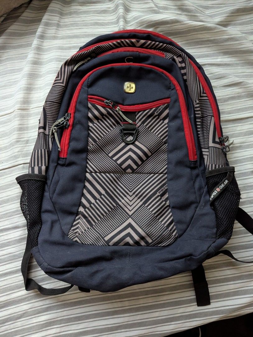 Swiss Gear Backpack Navy Blue Geometric Pattern (Category: Backpacks) located in Porac. Submitted by themightythrift (Listing ID 1443169108, Image 1). Description: - Swiss Gear backpack in navy blue - Stylish geometric pattern - Multiple compartments and pockets for organization - Padded shoulder straps and back panel for comfort - Side mesh pockets for water bottles - Ideal for school, work, or travel.