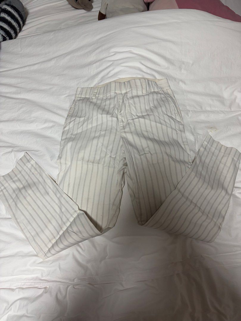 Uniqlo Striped Elastic Waist Pants (medium) (Category: Other Bottoms) located in Manila. Submitted by imda1 (Listing ID 1443267992, Image 3). Description: - Uniqlo Pants - Size: Medium (M) - Color: Cream with thin grey stripes - Features: Elastic waistband - Material: Cotton, Spandex, Rayon blend - Condition: Light yellow stains visible due to storage, but still washable (please check photos for details).