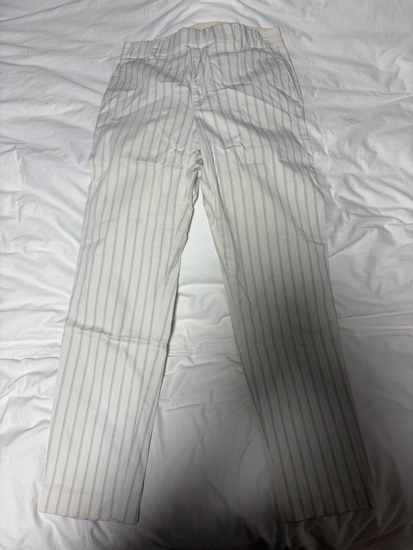 Uniqlo Striped Elastic Waist Pants (medium) (Category: Other Bottoms) located in Manila. Submitted by imda1 (Listing ID 1443267992, Image 1). Description: - Uniqlo Pants - Size: Medium (M) - Color: Cream with thin grey stripes - Features: Elastic waistband - Material: Cotton, Spandex, Rayon blend - Condition: Light yellow stains visible due to storage, but still washable (please check photos for details).