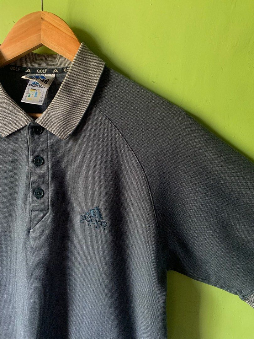 Vintage 1990s Adidas golf button up polo (Category: Tshirts & Polo Shirts ) located in Cagayan de Oro. Submitted by premium_thrifts (Listing ID 1443179847, Image 2). Description: Gray green colorway. Good condition. Issues: minimal lints, and 2 scratches - MEASUREMENTS: L26.2/27.5" x W20.5" Fits Medium - Large Add shipping fee (via JRS or J&T).