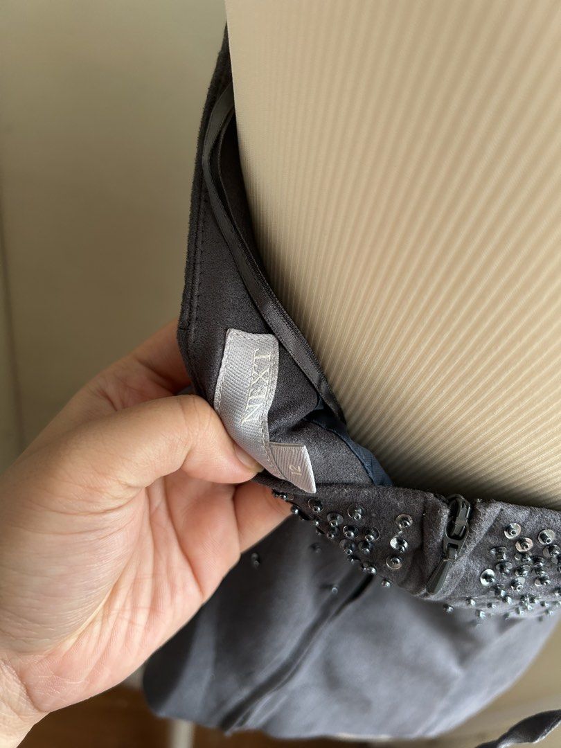 Vintage 2000s Embellished Sequin Halter Neck Top (Category: Sleeveless) located in Pasig City. Submitted by declutterwithme_agb (Listing ID 1443314248, Image 3). Description: - Dark grey halter neck top - Covered in shimmering sequins and beads around the bust - Zip closure at the back - Ties at the neck - Ideal for parties or a night out.