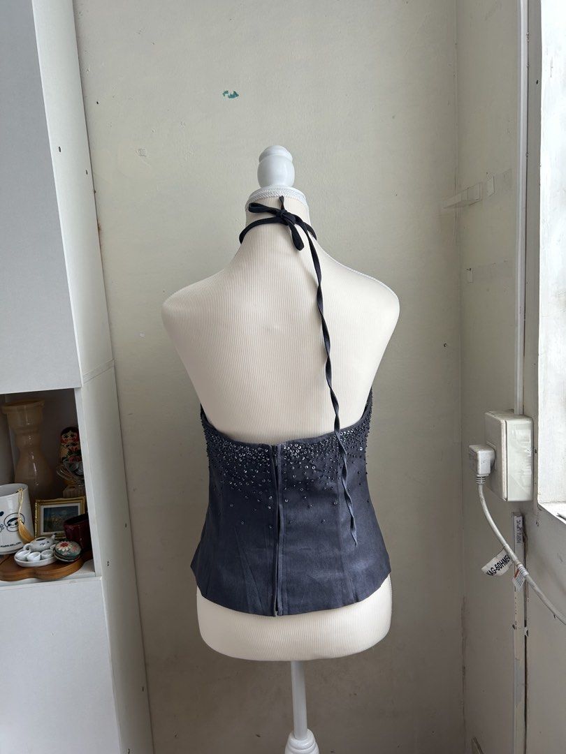 Vintage 2000s Embellished Sequin Halter Neck Top (Category: Sleeveless) located in Pasig City. Submitted by declutterwithme_agb (Listing ID 1443314248, Image 2). Description: - Dark grey halter neck top - Covered in shimmering sequins and beads around the bust - Zip closure at the back - Ties at the neck - Ideal for parties or a night out.