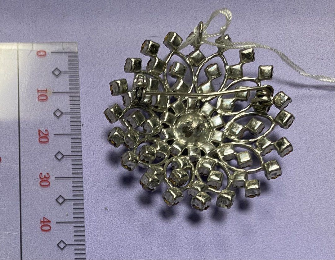 Vintage Snowflake Brooch with Rhinestones (Category: Brooches) located in Mabalacat. Submitted by somethingoldsomethingnew28 (Listing ID 1443182404, Image 2). Description: - Sparkly snowflake design brooch/pendant - Adorned with clear and iridescent rhinestones - Silver-tone metal setting - Measures approximately 5cm across - Secure pin closure on the back - Adds a touch of sparkle to coats, scarves, bags, and more!.