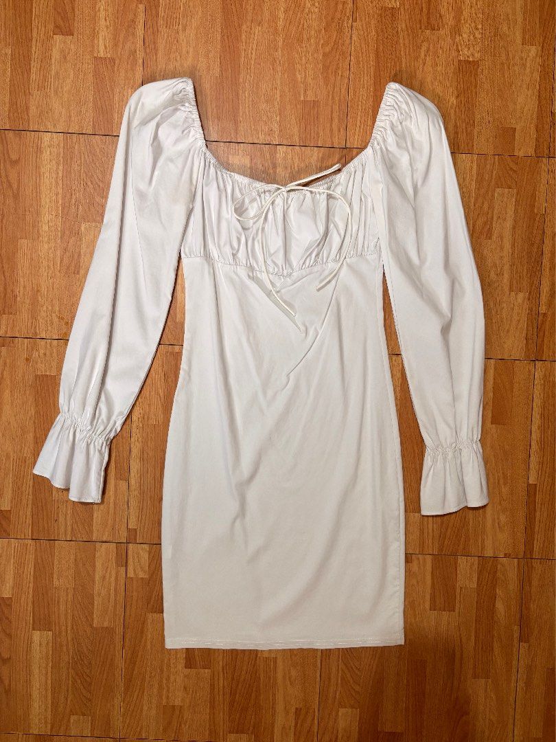 White Square Neck Ruched Long Sleeve Mini Dress (Category: Dresses) located in Antipolo. Submitted by missythings (Listing ID 1443207944, Image 3). Description: - White mini dress - Square neckline with tie detail - Long puff sleeves with ruffled cuffs - Fitted silhouette - Ideal for night outs or special occasions - Chic and stylish design.