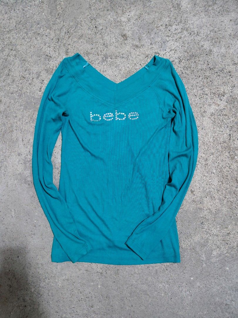 Y2k Bebe Long Sleeve Rhinestone Logo Top (Category: Blouses) located in Villasis. Submitted by trip_thrift15 (Listing ID 1443276635, Image 3). Description: - Bebe long sleeve top - Features Bebe logo with rhinestones across the chest - Versatile styling: can be worn off the shoulder or as a V-neck - Ribbed material for a comfortable fit - Ideal for night outs or casual wear complete rhinestones issue/flaws(check last 2 pics.) MOP-GCASH JNT COURIE