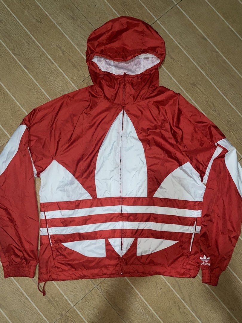 Adidas Big Trefoil Windbreaker Jacket Red White (Category: Coats, Jackets and Outerwear) located in Manila. Submitted by lianneaori10034 (Listing ID 1443327792, Image 1). Description: - Classic Adidas windbreaker in vibrant red. - Features the iconic large white Trefoil logo on the front. - White accents on sleeves and sides for a sporty look. - Hooded design for added versatility. - Adjustable drawstring hem for a customized fit. - Ideal for eve