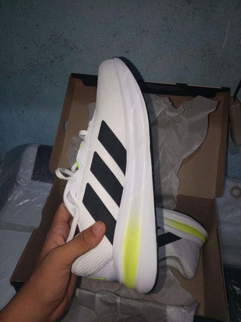 Adidas Galaxy 7 M Running Shoes (Category: Sneakers) located in Manila. Submitted by happylion.79856e (Listing ID 1443441263, Image 3). Description: - Brand: Adidas - Type: Running Shoes - Color: White with black stripes and neon yellow accents - Size: 10.5 US Men's - Condition: Brand new, never used - Includes: Original box.