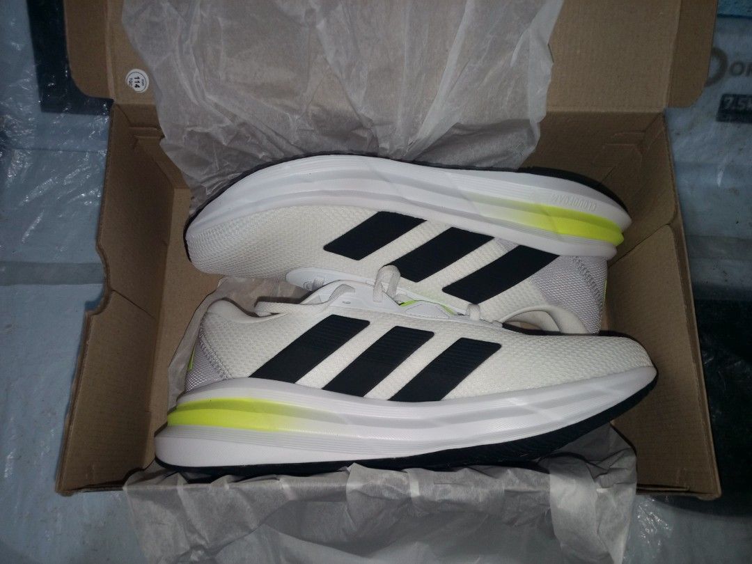 Adidas Galaxy 7 M Running Shoes (Category: Sneakers) located in Manila. Submitted by happylion.79856e (Listing ID 1443441263, Image 2). Description: - Brand: Adidas - Type: Running Shoes - Color: White with black stripes and neon yellow accents - Size: 10.5 US Men's - Condition: Brand new, never used - Includes: Original box.