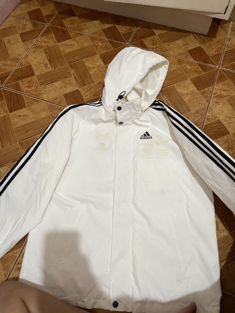 Adidas White Hooded Jacket with Black Stripes (Category: Coats, Jackets and Outerwear) located in Quezon City. Submitted by dfwdz (Listing ID 1443415135, Image 1). Description: White Adidas jacket with the classic three black stripes on the sleeves. It has a hood with drawstrings. There are some faint yellow marks on the front, as shown in the photos. Button closure down the front. Great for casual wear or light rain..