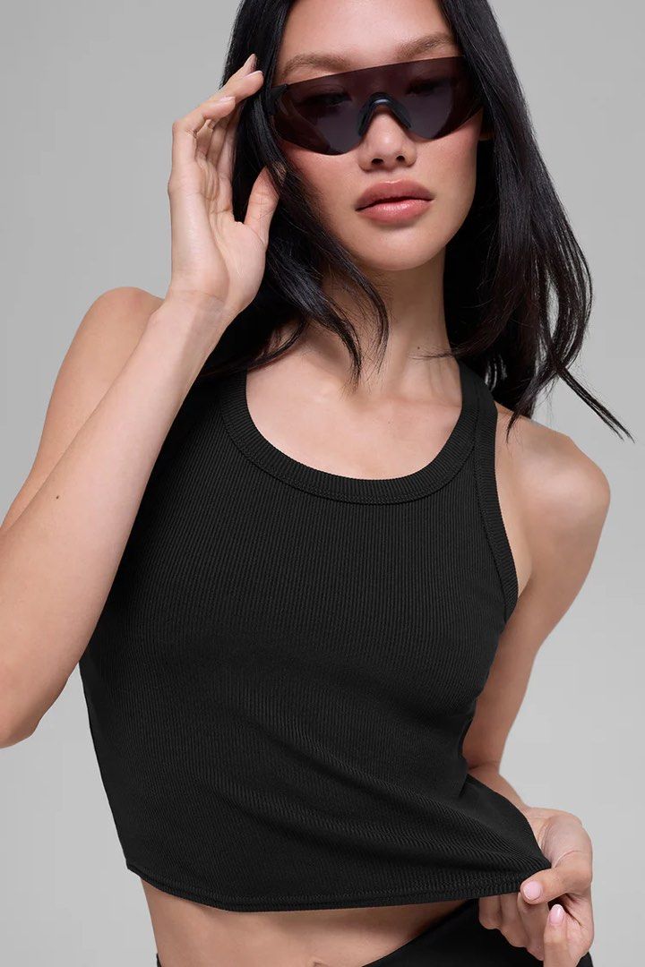 Alo Goddess Ribbed Go-To Tank Black XS (Category: Activewear) located in Singapore. Submitted by shopthemoon (Listing ID 1443344482, Image 3). Description: - RTP: $94 - Brand: Alo Yoga - Color: Black - Style: Ribbed Cropped Tank Top - Features: Light compression, performance fabric - Fit: Cropped - Comfort: Super comfortable and stretchy - Versatility: Great for workouts or everyday wear.