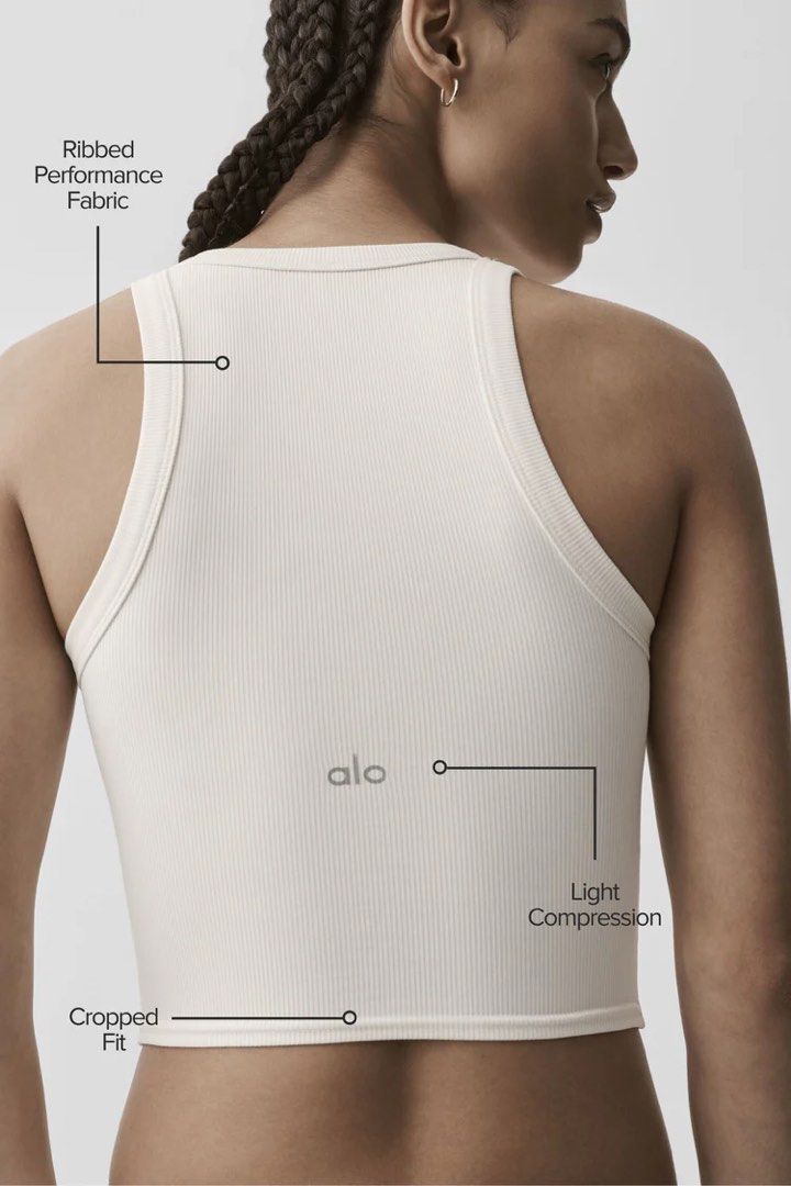 Alo Goddess Ribbed Go-To Tank White XS (Category: Activewear) located in Singapore. Submitted by shopthemoon (Listing ID 1443344295, Image 2). Description: - RTP: $94 - Brand: Alo - Style: Ribbed cropped tank top - Features: Racerback, performance fabric, light compression - Fit: Stretchy and super comfy - Versatile: Perfect for workouts or casual wear.
