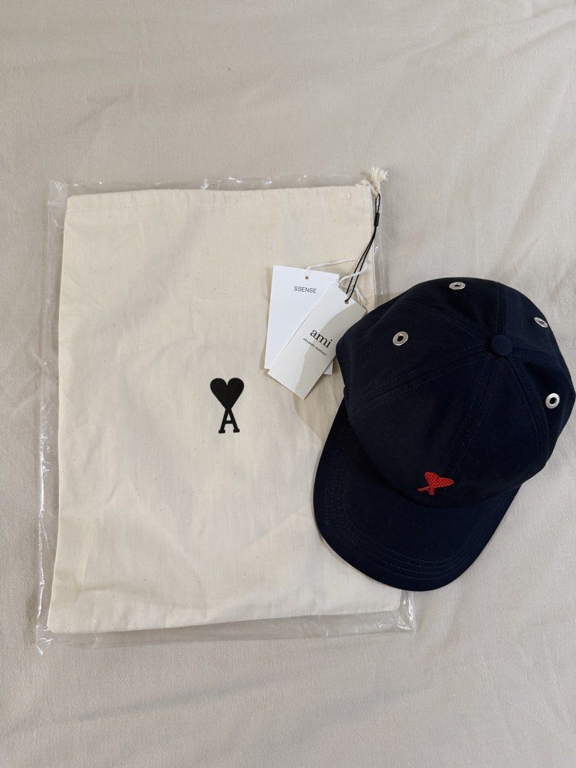 AMI Paris Ami de Coeur Cap Navy Blue (Category: Caps & Hats) located in Las Pinas. Submitted by kristinemunin (Listing ID 1443371126, Image 2). Description: - AUTHENTIC - Bought from Ssense - Like new condition/ no issue - Navy blue cap from AMI Paris - Features signature red Ami de Coeur logo embroidery - Adjustable strap at the back with AMI branded buckle - Comes with a dust bag and tags No exchange. No returns..