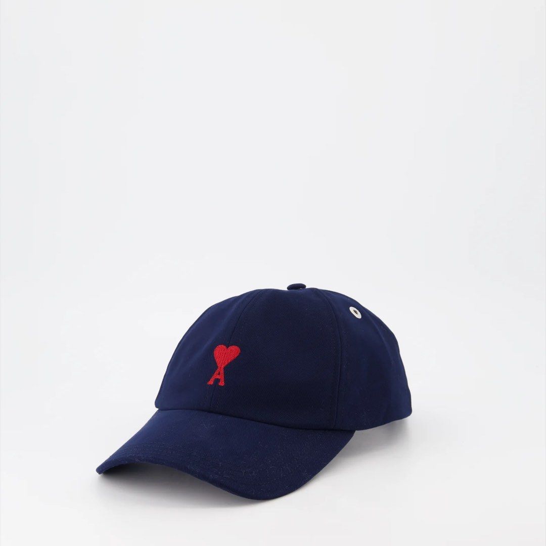 AMI Paris Ami de Coeur Cap Navy Blue (Category: Caps & Hats) located in Las Pinas. Submitted by kristinemunin (Listing ID 1443371126, Image 1). Description: - AUTHENTIC - Bought from Ssense - Like new condition/ no issue - Navy blue cap from AMI Paris - Features signature red Ami de Coeur logo embroidery - Adjustable strap at the back with AMI branded buckle - Comes with a dust bag and tags No exchange. No returns..