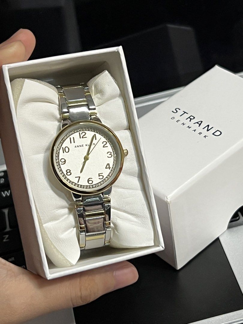 Anne Klein Two-Tone Watch with Crystal Bezel (Category: Women's Watches) located in Antipolo. Submitted by stormieluv (Listing ID 1443410473, Image 1). Description: - Anne Klein two-tone metal band watch - White dial with gold-tone hour markers and hands - Sparkling crystal bezel - Includes original box - Japan movement, China band - Model: AK/3779SVTT BRAND NEW !!! natambak lang !! bought from DUBAI.