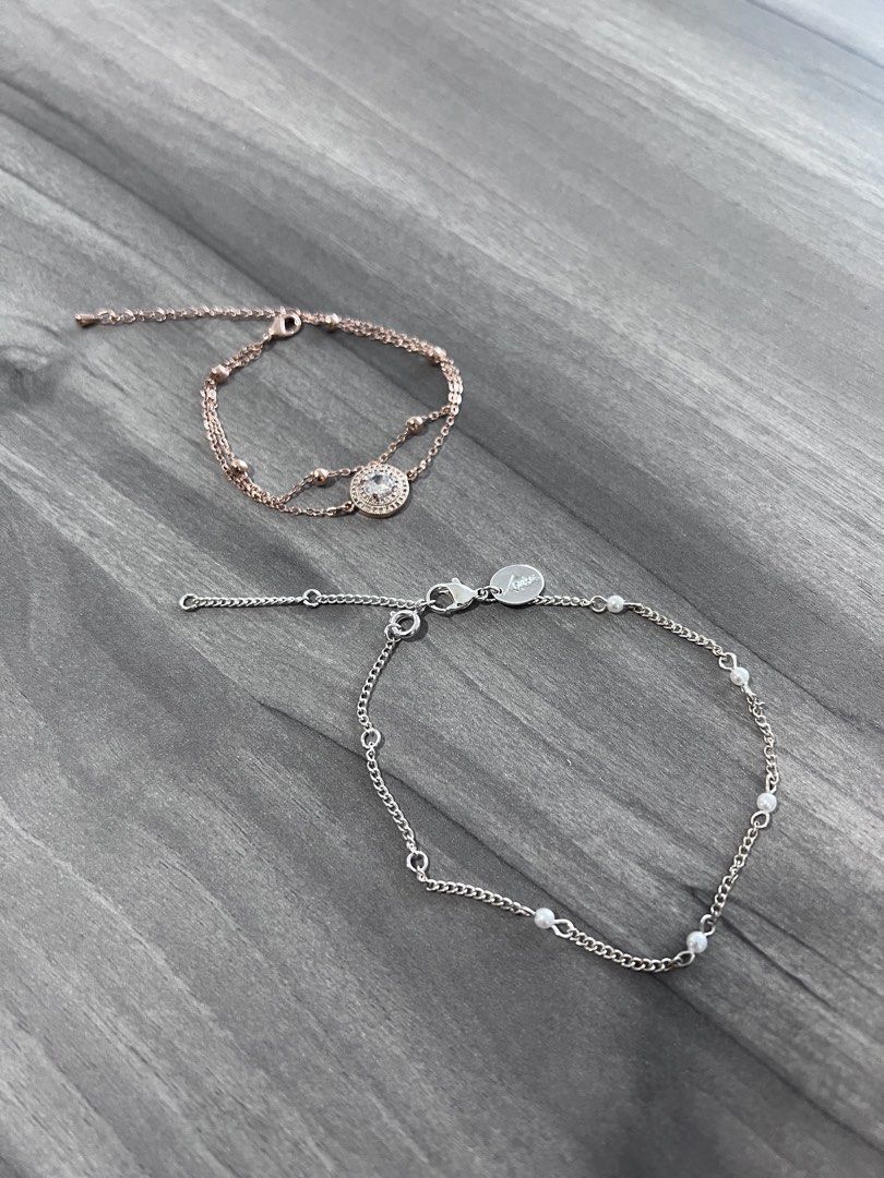 Assorted Bracelets (Category: Bracelets) located in Singapore. Submitted by george_20. (Listing ID 1443399091, Image 1). Description: - $7 each - Rose gold bracelet: double chain, circular charm with clear stones - Silver bracelet: chain with small pearl details - Both bracelets feature adjustable clasps - Ideal for layering or wearing individually.