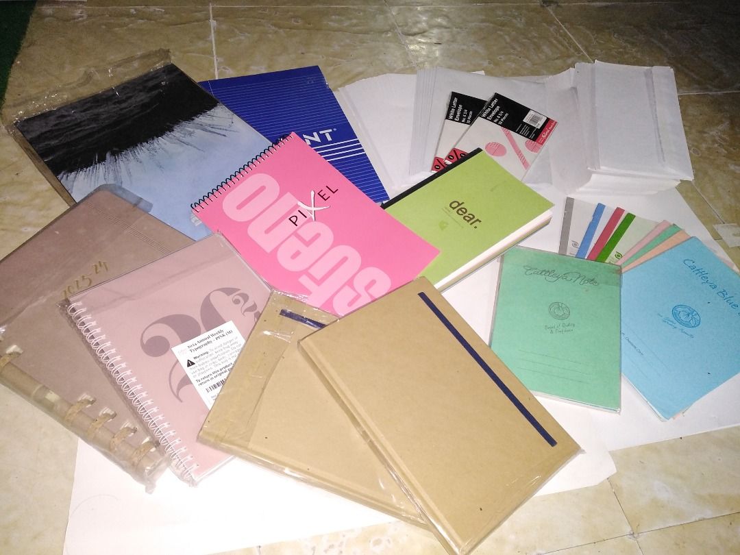 Assorted Notebooks and Stationery Items (Category: Stationery & School Supplies) located in Taguig. Submitted by juls0607 (Listing ID 1443439097, Image 1). Description: - Bundle of notebooks and stationery - Includes spiral-bound notebooks, planners, and notepads - Some items are brand new in original packaging - Variety of colors and styles available - Ideal for school, work, or personal organization - ALL IN THE PHOTOS FOR 300.00.