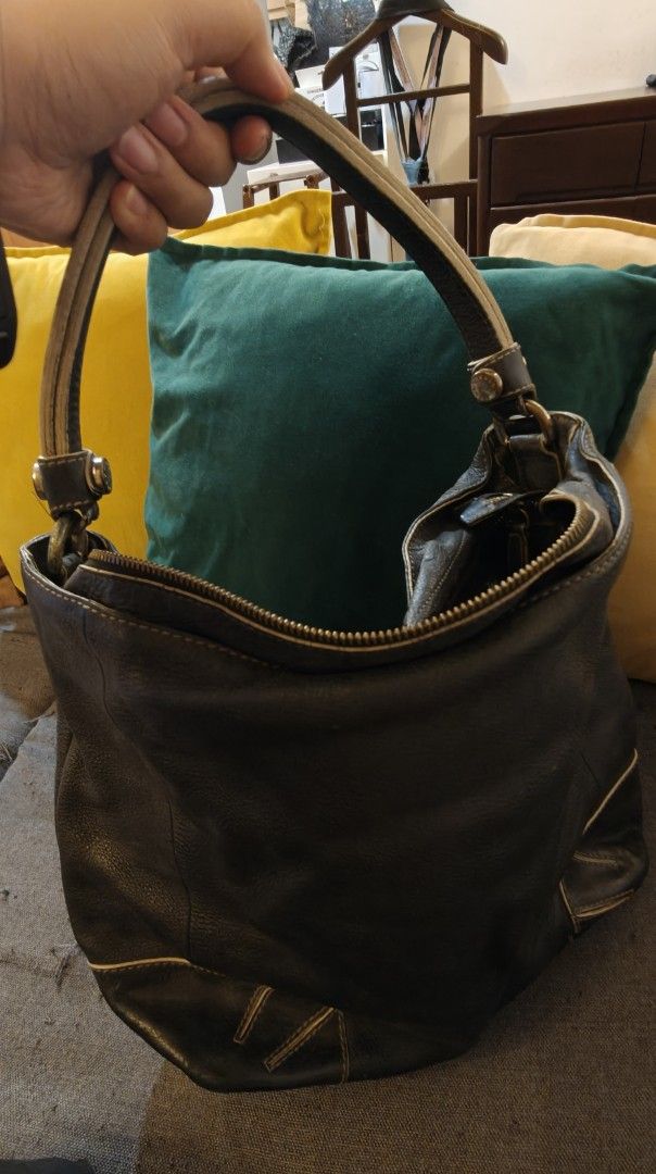 Authentic Furla Dark Brown Leather Hobo Shoulder Bag (Category: Shoulder Bags) located in Manila. Submitted by trustedthrifter (Listing ID 1443448796, Image 2). Description: - Dark brown Furla leather hobo bag - Soft leather with some creasing - Zipper closure at the top - Two rounded handles - Stitching detail on the front corners - Roomy and great for everyday use.