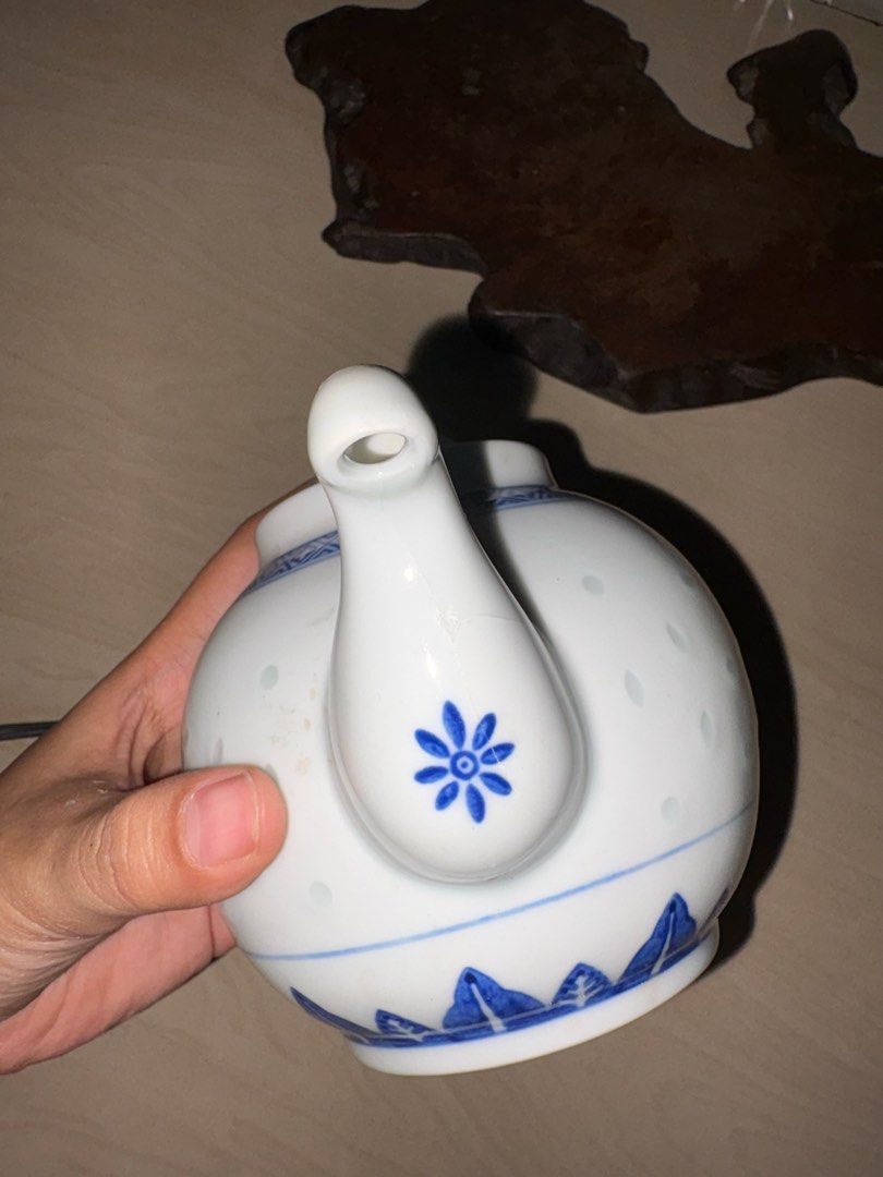 Blue and White Porcelain Teapot with Intricate Pattern (Category: Coffee & Tea Tableware) located in Bacoor. Submitted by dawnandust (Listing ID 1443334317, Image 3). Description: - Classic blue and white porcelain teapot - Features delicate geometric pattern on lid and base - Scattered small floral motifs on the body - Smoothly curved spout and handle - Ideal for serving tea or as a decorative piece - Approximate dimensions: [insert height] tall