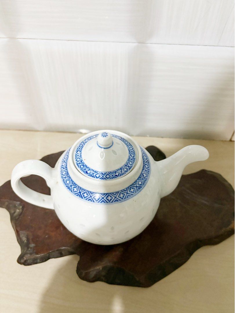 Blue and White Porcelain Teapot with Intricate Pattern (Category: Coffee & Tea Tableware) located in Bacoor. Submitted by dawnandust (Listing ID 1443334317, Image 2). Description: - Classic blue and white porcelain teapot - Features delicate geometric pattern on lid and base - Scattered small floral motifs on the body - Smoothly curved spout and handle - Ideal for serving tea or as a decorative piece - Approximate dimensions: [insert height] tall