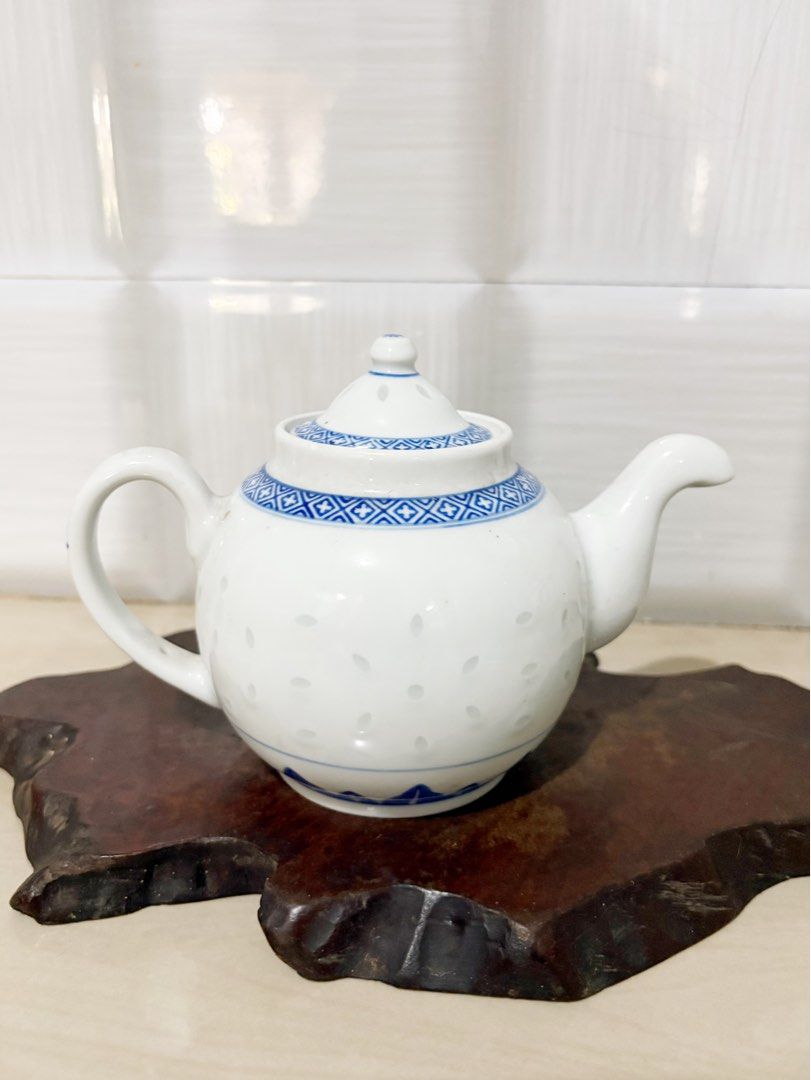 Blue and White Porcelain Teapot with Intricate Pattern (Category: Coffee & Tea Tableware) located in Bacoor. Submitted by dawnandust (Listing ID 1443334317, Image 1). Description: - Classic blue and white porcelain teapot - Features delicate geometric pattern on lid and base - Scattered small floral motifs on the body - Smoothly curved spout and handle - Ideal for serving tea or as a decorative piece - Approximate dimensions: [insert height] tall