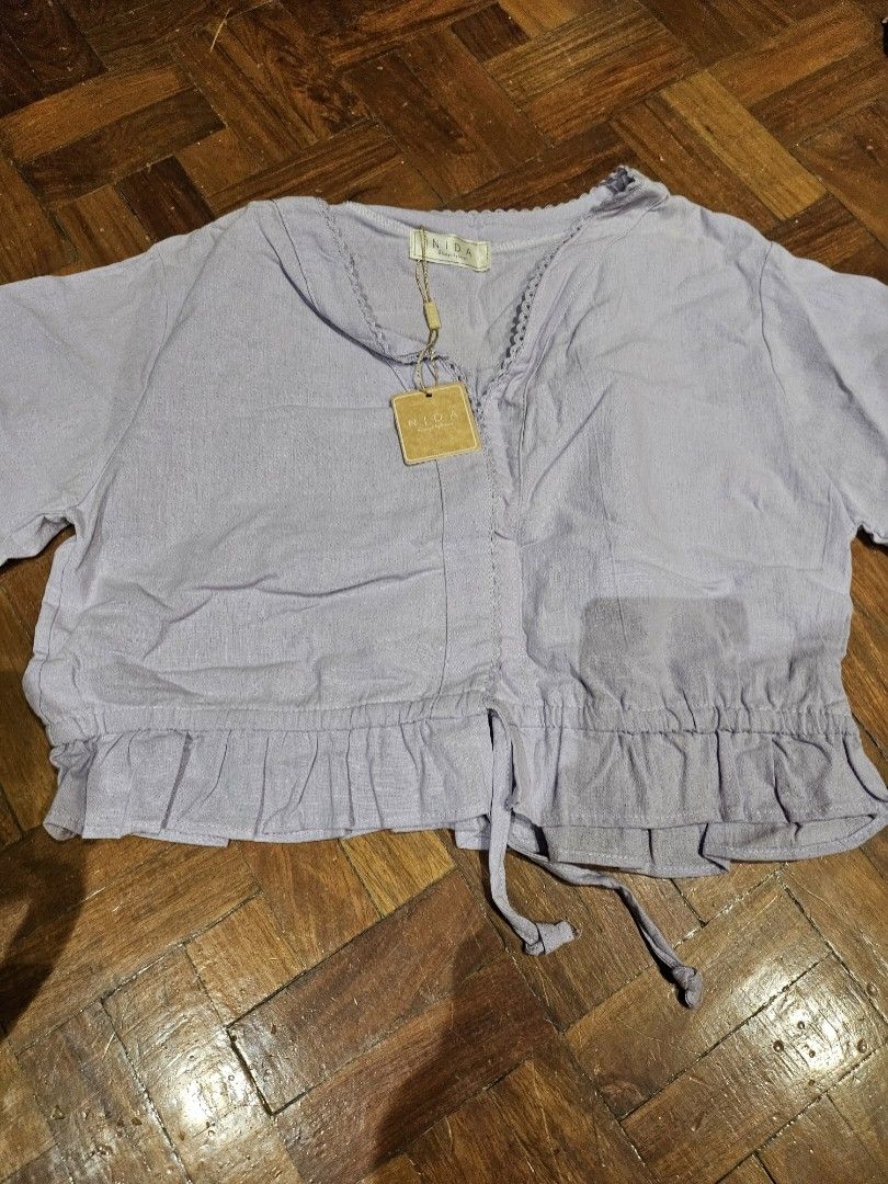BNWT Lilac Ruffled Linen Crop Blouse with Front Ties (Category: Others Tops) located in Paranaque City. Submitted by dlilly (Listing ID 1443452506, Image 2). Description: Selling this gorgeous lilac/lavender linen crop top. I bought it in Thailand but never got around to wearing it. Was told it's free size, but width is around 17.5" when laid flat. RFS: Decluttering!.